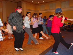 Delegates kick their legs up at the dance